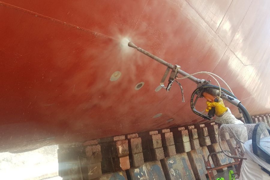 Crew performing blasting works on a marine structure”