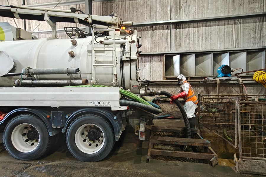 Crew managing waste disposal with a vacuum truck in Auckland